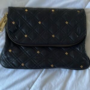 Soft leather clutch with gold accents and zippers